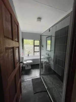 a bathroom with a tub and a toilet and a sink at African Vibes in Marloth Park