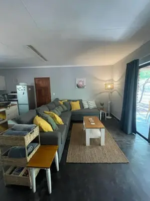 a living room with a couch and a table at African Vibes in Marloth Park