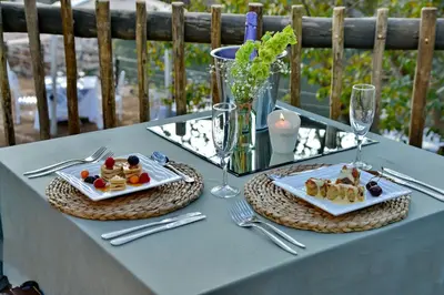 a table with two plates of food on it at Thanda Manzi Country Hotel in Centurion