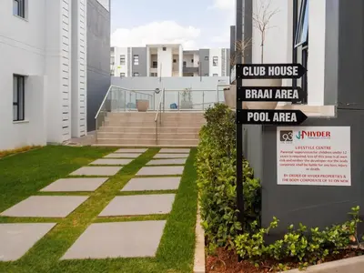 a street sign in front of a building at Luminant Escapes - with power backup in Midrand