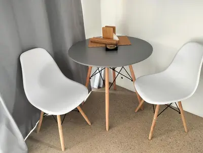 two white chairs and a table with a box on it at 20 on Middle in Polokwane
