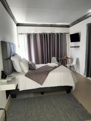 a bedroom with a large bed with a curtain at 20 on Middle in Polokwane