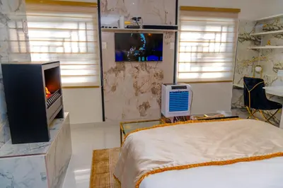 a bedroom with a tv and a bed in a room at Homes of Ace Studio 1 in Pretoria