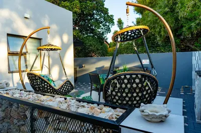 two pictures of chairs and a table with rocks at Homes of Ace Studio 1 in Pretoria