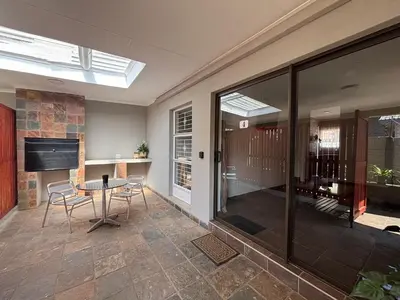 a living room with a table and some windows at 59 van Heerden in Mokopane