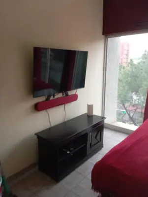a bedroom with a flat screen tv on the wall at Greggs Place at Capital Hill Arcadia in Pretoria