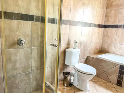 a bathroom with a toilet and a shower at Bobisemo Lux Guesthouse in Tierpoort
