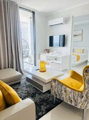 a living room with a couch and a table at Waterfall Peaceful Oyster in Midrand