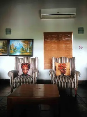 two chairs and a coffee table in a living room at The Yellow House in Brits