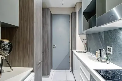 a kitchen with white counters and a glass door at Penthouse and Apartment at The Capital Triology Menlyn Maine in Pretoria