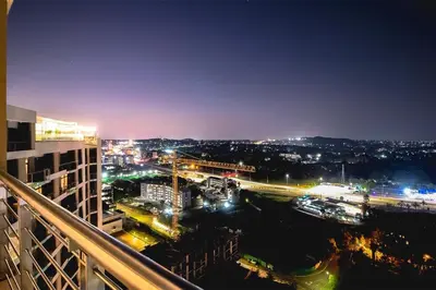 a view of a city at night with lights at Penthouse and Apartment at The Capital Triology Menlyn Maine in Pretoria