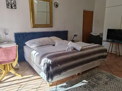 a bedroom with a bed with a blanket on it at Sun and Stars in Benoni
