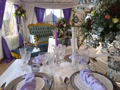 a table with glasses and purple napkins on it at Sun and Stars in Benoni
