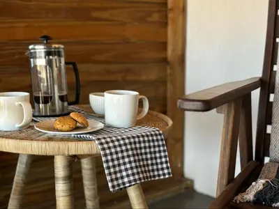 a table with two coffee cups and cookies on it at Butjani Lodge in Cullinan
