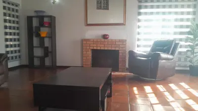 a living room with a chair and a coffee table at Mandy place in Sandown