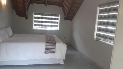 a bedroom with a white bed and two windows at Mandy place in Sandown
