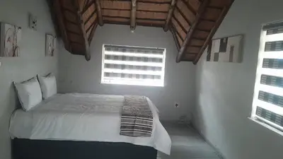 a bedroom with a white bed with a window at Mandy place in Sandown