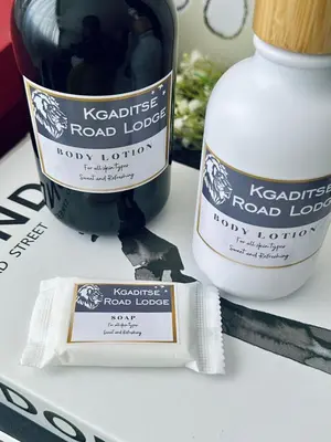 a bottle of road lager next to a bottle of wine at KGADITSE ROAD LODGE in Moletlane