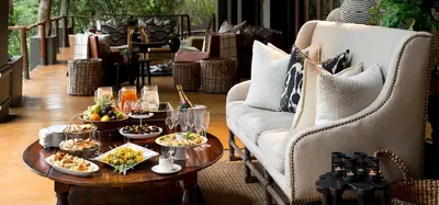 a table with plates of food on top at Lion Sands - Tinga Lodge in Skukuza