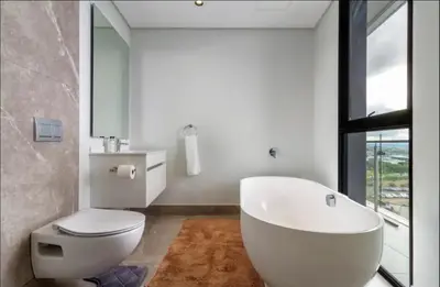 a bathroom with a white tub and a toilet at Ellipse Cassini @ Waterfall (Fili) in Midrand