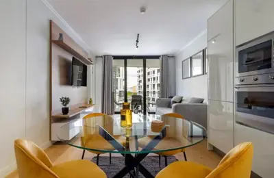 a living room with a glass table and chairs at Ellipse Cassini @ Waterfall (Fili) in Midrand