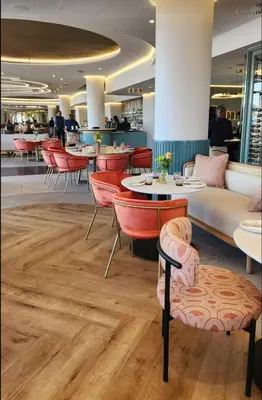 a restaurant with red chairs and tables in a restaurant at Ellipse Cassini @ Waterfall (Fili) in Midrand