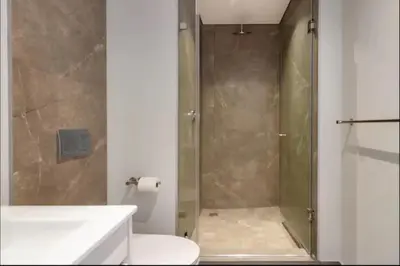 a bathroom with a shower with a toilet and a sink at Ellipse Cassini @ Waterfall (Fili) in Midrand