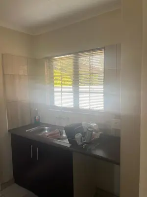 a kitchen counter with a sink and a window at Centurion Family House in Centurion