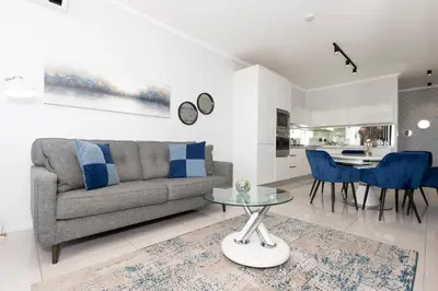 a living room with a couch and a table at The Executive Apartment in Ellipse Waterfall City in Midrand