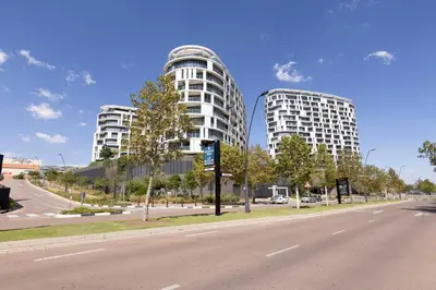 two tall buildings on the side of a road at The Executive Apartment in Ellipse Waterfall City in Midrand