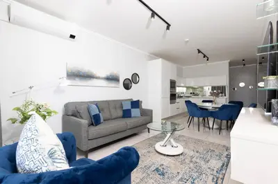 a living room with a couch and a table at The Executive Apartment in Ellipse Waterfall City in Midrand