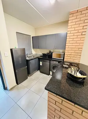 a kitchen with a counter top in a room at The Place at Mall of Africa 2 in Midrand