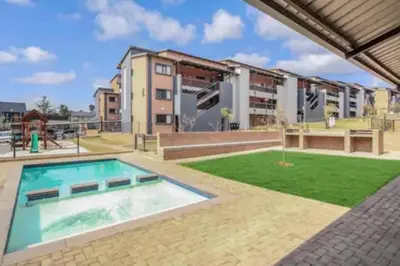 an image of an apartment complex with a swimming pool at The Place at Mall of Africa 2 in Midrand