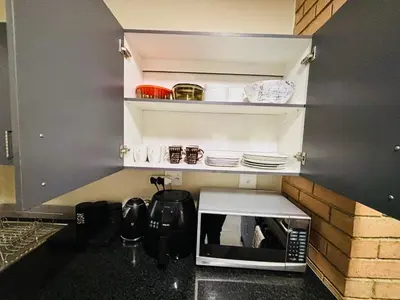 a microwave oven sitting on a counter in a kitchen at The Place at Mall of Africa 2 in Midrand