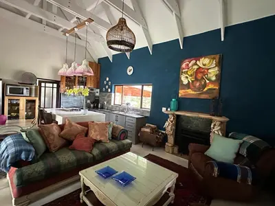 a living room with a couch and a table at Giverny in Dullstroom