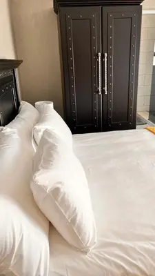 a white bed with white pillows on top of it at Nandoni Junction GuestVilla, Nandoni Thohoyandou in Vendaland