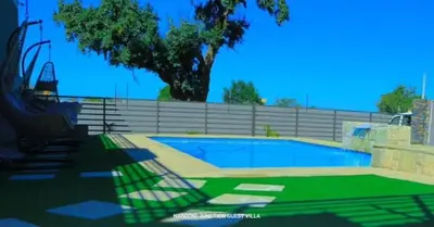 a swimming pool in a yard next to a fence at Nandoni Junction GuestVilla, Nandoni Thohoyandou in Vendaland