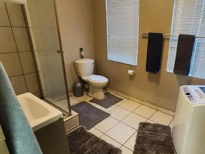 a bathroom with a toilet and a sink at Middelbult Guesthouse by Heybert in Secunda