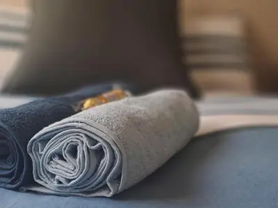 a rolled up sock on a persons foot on a bed at Middelbult Guesthouse by Heybert in Secunda