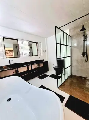 a room with a bathroom with a toilet and mirrors at Luxury GuesthouseCo FarmHouse in Marloth Park