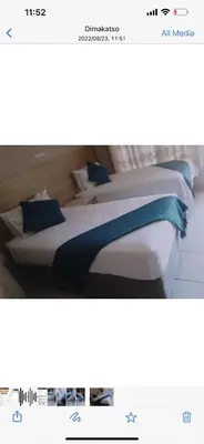 two beds with blue pillows in a room at Rethabile Guesthouse in Bochum