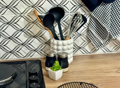 a kitchen counter with utensils and a container with a plant at Sugar Plum Rest in Polokwane