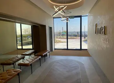 a waiting room with benches and a large window at Thando's Luxury Stays at Ellipse, Waterfall in Midrand