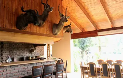 a restaurant with antlers hanging on the wall at ILANGA Lodge & Game Reserve in Kwarriekraal