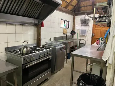 a kitchen with a stove and a sink at Sabella Bushveld Lodge in Marble Hall