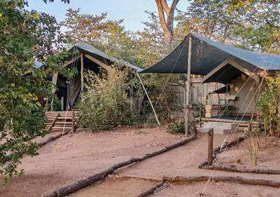 a house with a tent in front of it at Khanya Safari Lodge in Phalaborwa