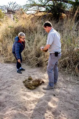 a man and a woman standing next to a dog at Khanya Safari Lodge in Phalaborwa