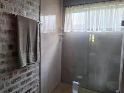 a bathroom with a shower with a glass door at 1@Kruger Unit 3 in Mokopane