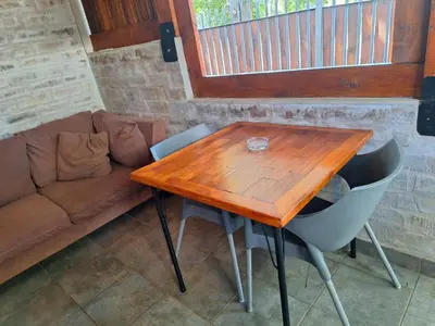 a wooden table and some chairs and a couch at 1@Kruger Unit 3 in Mokopane