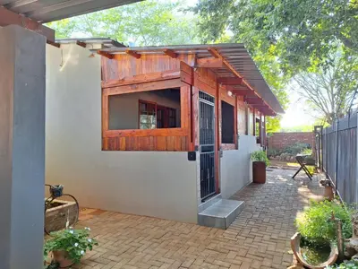 a house with a wooden door and a patio at 1@Kruger Unit 3 in Mokopane